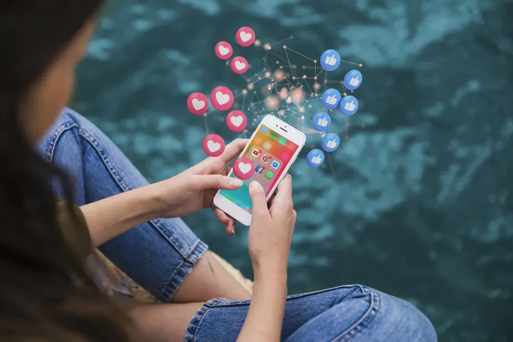 Photo of sitting girl browsing social media with infographics around phone.